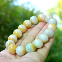 ราคา สร้อยข้อมือหยกพม่าแท้เหลืองน้ำผึ้งติดขาว ขนาดเม็ดหยก 14 mm เนื้อแก้ว สีหายาก (1731397546851927286)